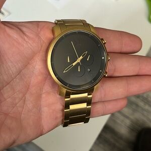 MVMT Chrono watch lion gold, matching hands with a dark backing faceplate